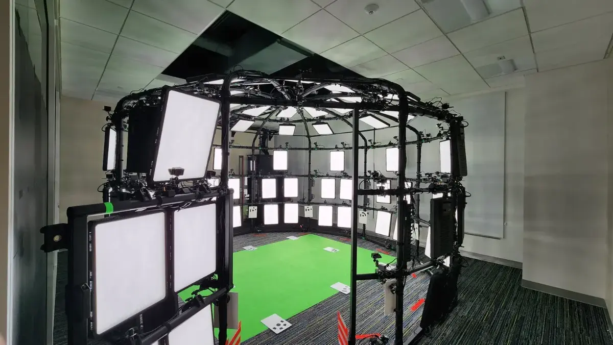 Volumetric capture dome build — camera and light rig over a green-screen floor
